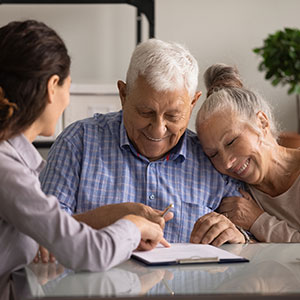 Elderly couple meeting with professional to discuss public benefit strategies